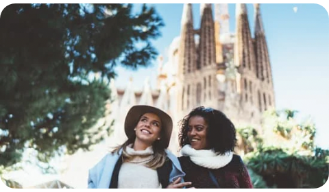 Photo of two expats living in Spain walking in front of Sagrada Familia in Barcelona